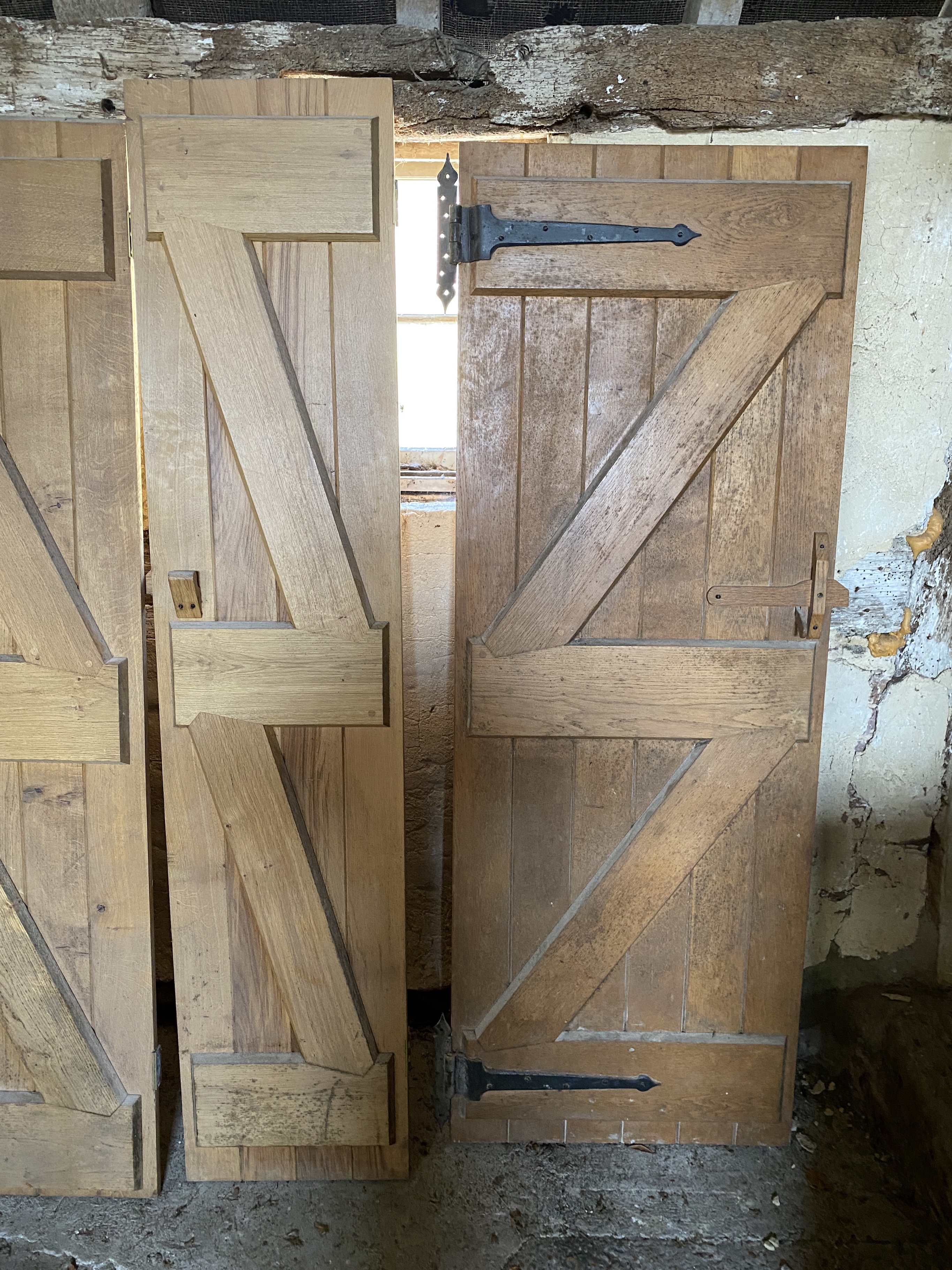 Three solid oak ledged and braced doors, 210 x 58.5cm; 204 x 44.5cm and 95 x 72cm, and a double sided panelled solid oak door, 200 x 64cm (4)